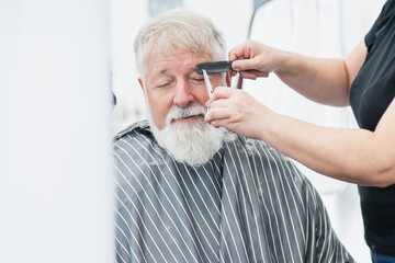 Senior man participating in a hair donation event