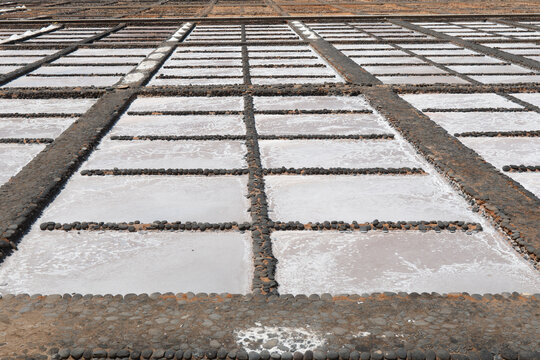 Geometric salt pans filled with crystallizing sea water