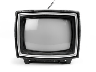 Old television set showing a static white screen in a dimly lit room.