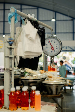 Market scene with analog scale and bottled drinks in El Salvador