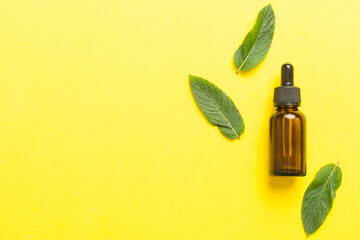 Natural Mint Essential Oil in a Glass Bottle. organic cosmetics with herbal extracts of mint on...