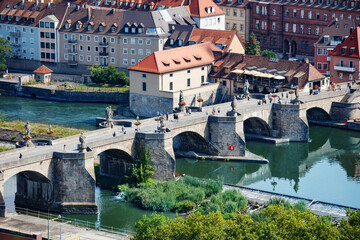 Obraz premium A beautiful Wurzburg along river with pedestrian Main bridge