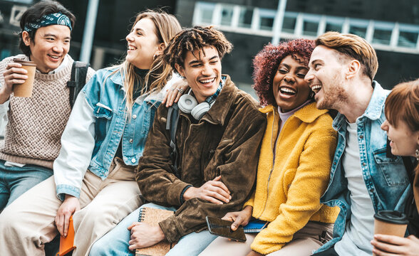 Multiracial students laughing and talking in college campus - Happy young people walking outside high school - Education life style and youth culture concept
