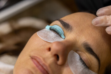 makeup artist doing eyelash lamination for a client