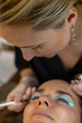 makeup artist doing eyelash lamination for a client
