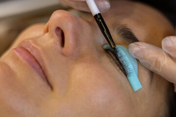 makeup artist doing eyelash lamination for a client