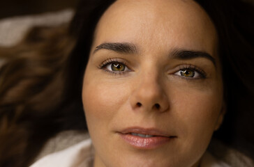portrait of a beautiful girl in a white blouse with dark hair smiling