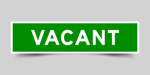 Square sticker label with word vacant in green color on gray background