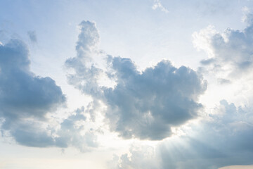 Fluffy white clouds drift across a clear blue sky, painting a beautiful summer day