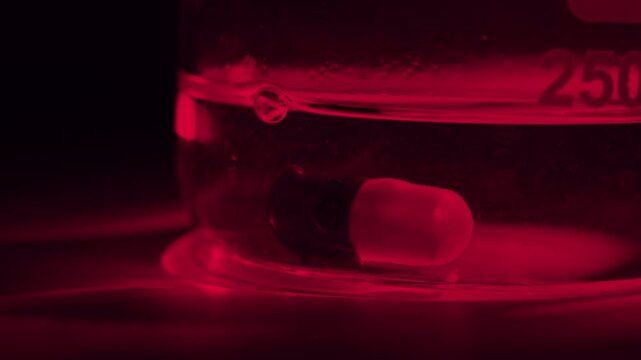 Timelapse of a pills drugs dissolving in a glass of water releasing the powder , medical Pharma pharmaceutical industry
