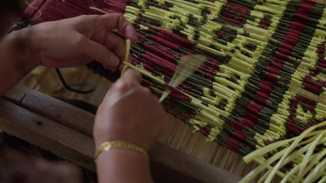 A woman Ikat tying pua kumbu traditional cloth preparation for dyeing