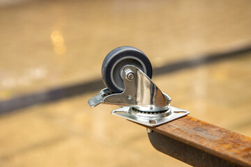 Obraz premium A metal caster on a metal table leg