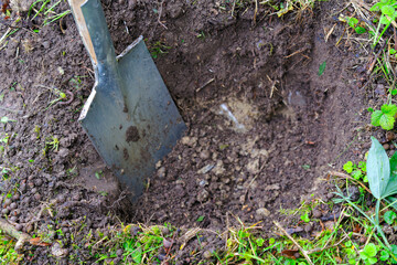 Close-up of spade at garden with soil and earthworm at Swiss City of Zürich on a rainy autumn day....