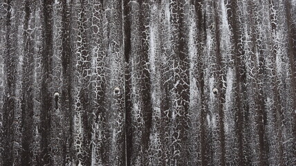 Obraz premium Black corrugated metal cracked paint texture