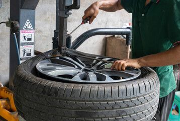 The car mechanic is repairing the tire