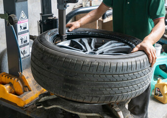 The car mechanic is repairing the tire