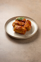 Stewed cabbage roll with rice and meat in tomato sauce on plate food