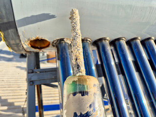 Sacrificial anode in solar hot water tank.