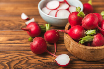 Fresh radish on textured wooden background. Organic natural garden radish slices. clipping root crop. Vegetables. Vegan. Diet products. Healthy food. Place for text. Copy space.