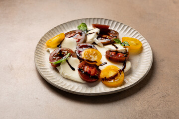 Caprese salad with sliced heirloom tomatoes close up healthy food