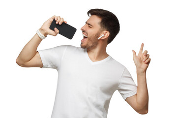 Young man in white t-shirt listening to music in wireless earphpones and singing in online karaoke...