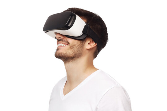 Fototapeta Young happy man smiling while enjoying and experiencing virtual reality with VR headset