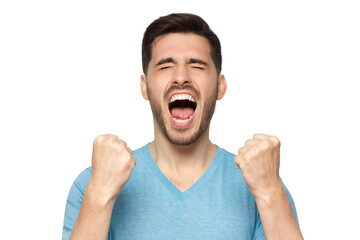 Close-up of emotional man screaming with joy and closed eyes, holding hands in gesture of winner