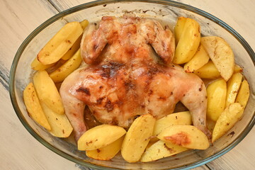 baked potatoes with fried chicken photo from above, crispy crust of fried chicken and potatoes with salt and pepper crust, baked dinner fried cooked food in glass dishes 