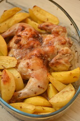 baked potatoes with fried chicken photo from above, crispy crust of fried chicken and potatoes with salt and pepper crust, baked dinner fried cooked food in glass dishes 