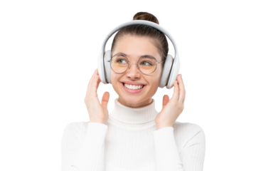 Portrait of happy girl listening to favorite music via wireless headphones, smiling and looking away