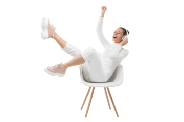 Young happy girl listening to music in white chair, wearing wireless headhones