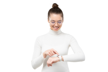 Young woman wearing eyeglasses and wristwatch, checking if she is in time, touching screen, smiling happily