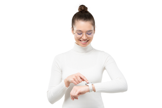 Young woman wearing eyeglasses and wristwatch, checking if she is in time, touching screen, smiling happily