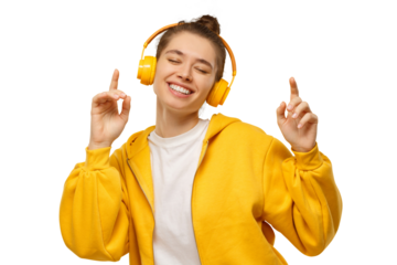 Young happy woman dancing to sounds of music in wireless headphones