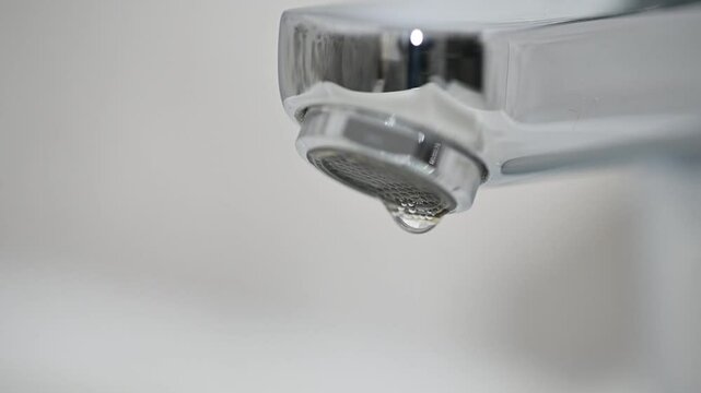 leaking faucet. dripping tap. water drops falling from faucet, extreme close up. wasted water run. plumbing issues. leaking tap, macro close up. save water. leaky faucet valve. saving family budget
