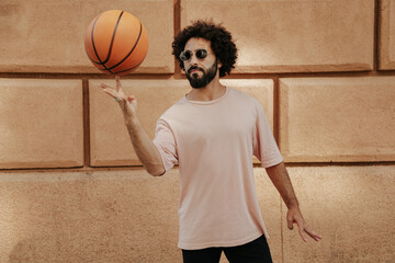 Young Arabian with a beard and afro hairstyle with basketball ball