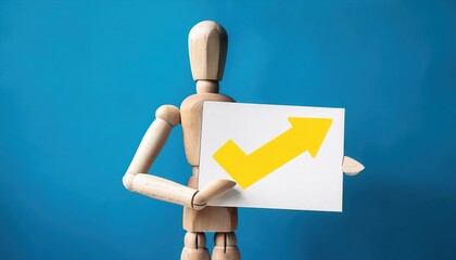 Wooden mannequin holding an upward trend sign, blue background.