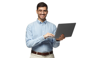 Confident young handsome businessman in blue shirt holding laptop and smiling at camera
