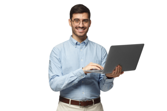 Confident young handsome businessman in blue shirt holding laptop and smiling at camera