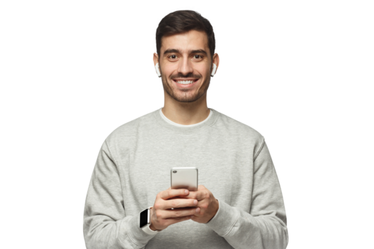 Young excited man standing, looking at camera with smile, holding phone with both hands