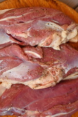 Texture of fatty fresh duck breast close up as background, texture of black meat of duck breast close up photo from above 