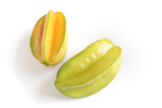 Two ripe juicy carambola starfruit whole  on white background. Averrhoa carambola, star apple, delicious tropical fruit.