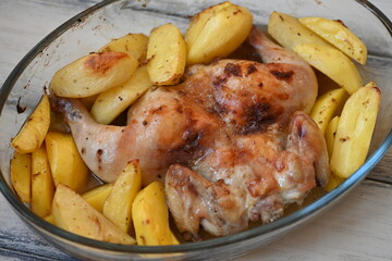 baked potatoes with roasted chicken photo from above, cinnamon crispy crust of roasted chicken and potatoes, baked dinner 