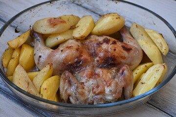 baked potatoes with roasted chicken photo from above, cinnamon crispy crust of roasted chicken and potatoes, baked dinner 