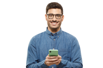 Young modern man in casual blue shirt and trendy glasses, holding phone in hands, exchanging and typing messages to his friends, looking at camera with smile