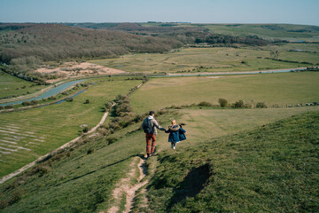 Father and daughter hiking on the hills of Eastbourne, Seven Sisters, England, UK