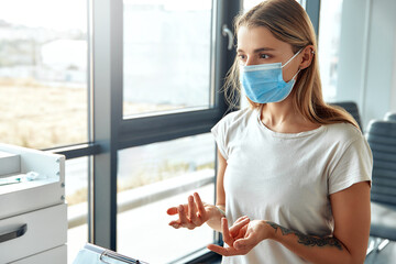 A Young Woman Wearing a Medical Mask Engaging in an Active Conversation with Someone