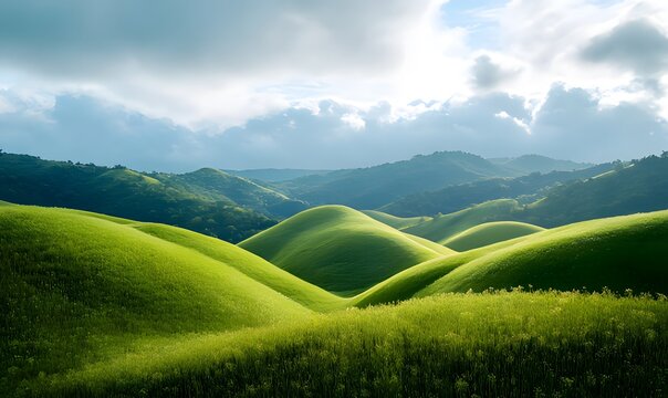 A breathtaking landscape of rolling green hills stretching towards a dramatic sky. The hills are covered in lush green grass, creating a sense of peace and tranquility