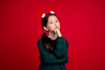 Photo portrait of cute little girl thoughtful touch chin dressed green christmas clothes theme...