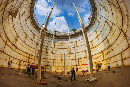 Tank oil internal overall ladder and shell plate confined space blue sky.